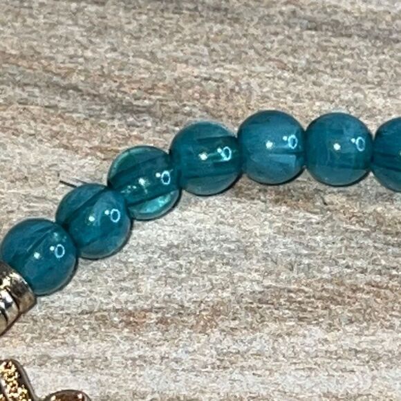 Light Blue Bead Stretch Bracelet with Gold Tone Hamza Hand - Picture 5 of 7